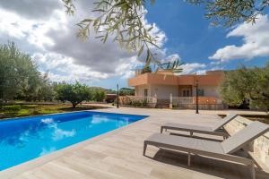 a villa with a swimming pool and a house at Villa Bartolomeo in Modica