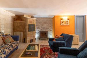 a living room with blue couches and a fireplace at Villa Bartolomeo in Modica