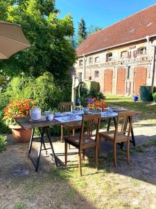 a wooden table with chairs and a table with flowers at Apartments-Schlamau19 in Schlamau
