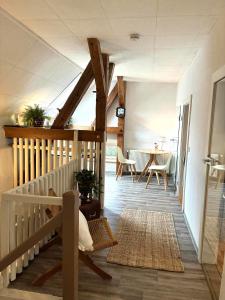 a room with a staircase with a table and chairs at Apartments-Schlamau19 in Schlamau