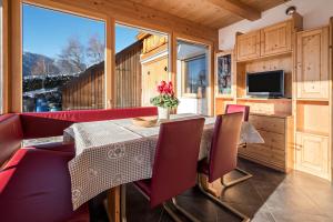 a dining room with a table and chairs and a television at Apartment Eisacktal in Mühlbach