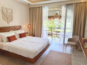 a bedroom with a large bed and a balcony at Laya Boutique Hotel in General Luna +22 photos