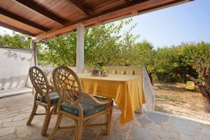a table and two chairs on a patio at Areti Orfeas Apartment 5 in Vasilikos