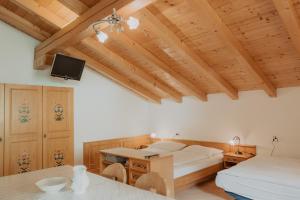 a bedroom with two beds and a tv on the ceiling at Gogererhof App Maria in Racines