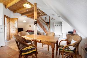 a dining room with a wooden table and chairs at Landhaus Peenemünde in Peenemünde
