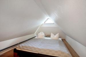 a small bedroom with a bed in the attic at Landhaus Peenemünde in Peenemünde
