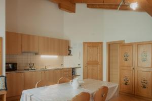 a kitchen with a table with a white table cloth on it at Gogererhof App Maria in Racines
