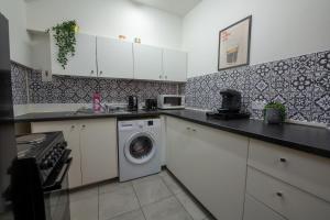 a kitchen with a washing machine and a washer at Apartment in cite center in Manchester