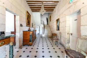a hallway with a tiled floor and a staircase at Le Mas de Kitty - Maison d'hôtes in Saint-Rémy-de-Provence