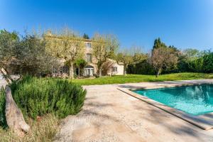 a house with a swimming pool in a yard at Le Mas de Kitty - Maison d'hôtes in Saint-Rémy-de-Provence