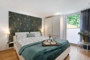 a bedroom with a large bed with a table on it at Grünzweig in Dobeneck