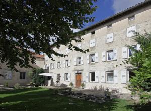 a large brick building with a lawn in front of it at le clos saint François in Beaune-sur-Arzon