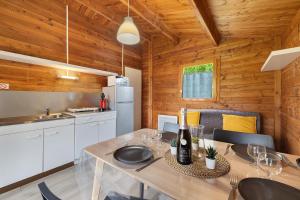 a kitchen and dining room with a table with wine glasses at Chalet confort 21 in Saint-Gervais +18 photos