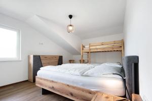 a bedroom with a wooden bunk bed and white walls at Haus Mader 2 in Riscone