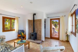 a living room with a fireplace and a stove at S Estanyol in Colonia de Sant Pere