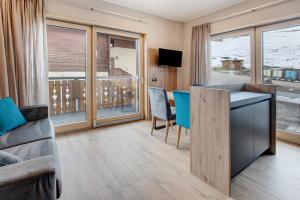 a living room with a couch and a table at Chalet Kb in Livigno