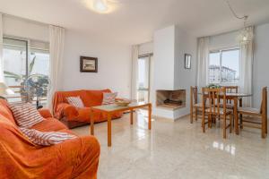 a living room with a couch and a table at Beach and Pool Laguna Beach A113 in Torrox