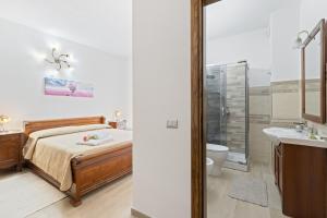 a bedroom with a bed and a shower and a sink at Affittacamere Le Muse in Scano Montiferro +88 photos