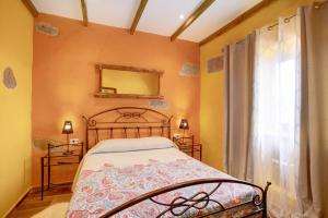 a bedroom with a bed and a mirror and a window at Casa Candelaria in Arico +22 photos