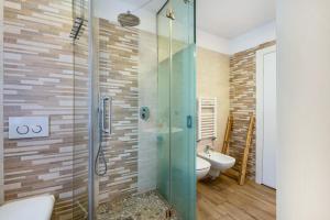 a bathroom with a glass shower and a sink at Casa Mara in Predazzo