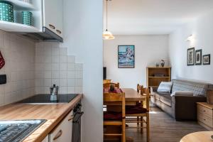 a kitchen and living room with a table and a couch at Casa Mara in Predazzo