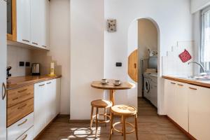 a small kitchen with a small table and two stools at Casa Mara in Predazzo +18 photos