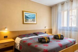 a bedroom with a bed with two bags on it at Casa Mara in Predazzo