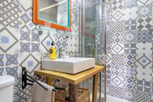 a bathroom with a sink and a shower at Casa Azul in Moledo +21 photos