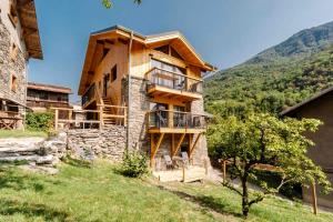 a wooden house with a balcony on a hill at Agréable Chalet 3 étoiles App 3 in Courchevel