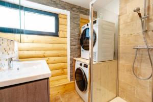 a washer and dryer in a bathroom with a sink at Agréable Chalet 3 étoiles App 3 in Courchevel