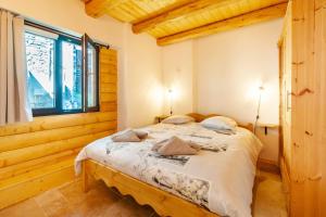 a bedroom with a bed in a room with a window at Agréable Chalet 3 étoiles App 3 in Courchevel