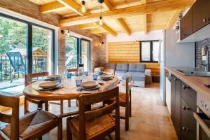 a kitchen and dining room with a table and chairs at Agréable Chalet 3 étoiles App 3 in Courchevel +8 photos