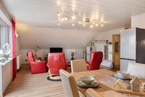 a kitchen and dining room with a table and red chairs at Haus Claudia in Fulda