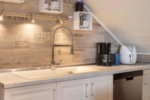 a kitchen with a sink and a counter top at Haus Claudia in Fulda +27 photos