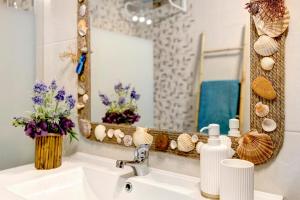 a bathroom with a sink and a mirror at Casa de Praia Tróia in Troia +16 photos