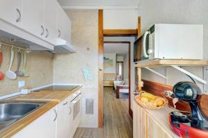 a kitchen with a sink and a counter top at Casa de Praia Tróia in Troia