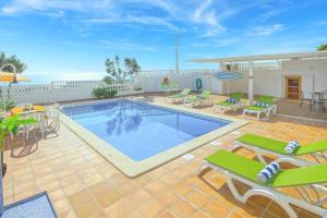 a swimming pool on a patio with chairs and a table at Villa Brigida in Patroves