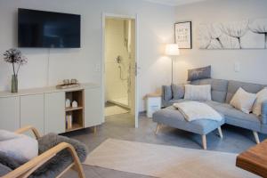 a living room with a couch and a chair at Ferienwohnung Auszeit in Salem