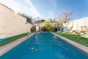 a swimming pool in the backyard of a house at Le Chalet Houda et spa en option in Nîmes