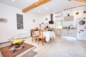 a kitchen and dining room with a table and chairs at Logement Le Buffet De La Gare in Falgueyrat +27 photos