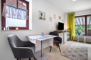 a living room with a table and chairs and a television at Ferienpark Gustow B09 in Gustow