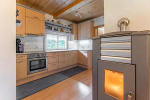 a kitchen with wooden cabinets and a stove top oven at Ferienhaus Waldenstein 1 in Waldenstein