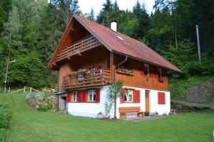 a small house with a bench in front of it at Ferienhaus Waldenstein 1 in Waldenstein