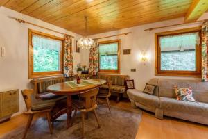 a living room with a table and a couch at Ferienhaus Waldenstein 1 in Waldenstein +13 photos