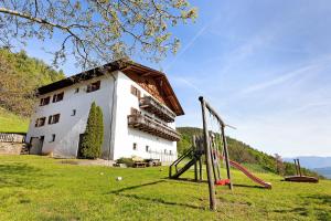 a building with a playground in front of it at Moar im Rumsein - Apt Saltenblick in Terlano