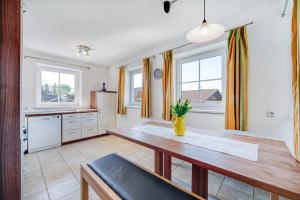 a kitchen with a wooden table and some windows at Haus Reichl in Berndorf bei Salzburg +37 photos