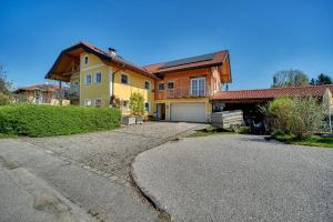 a large house with a driveway in front of it at Haus Reichl in Berndorf bei Salzburg