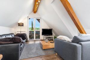 a living room with two couches and a tv at Ferienwohnung Moritz in Lahr