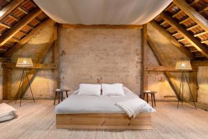 a bed in the middle of a room with two lamps at Apartments-Schlamau19 in Schlamau