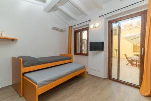 a room with a bench and a sliding glass door at Rifla Vacanze in La Maddalena